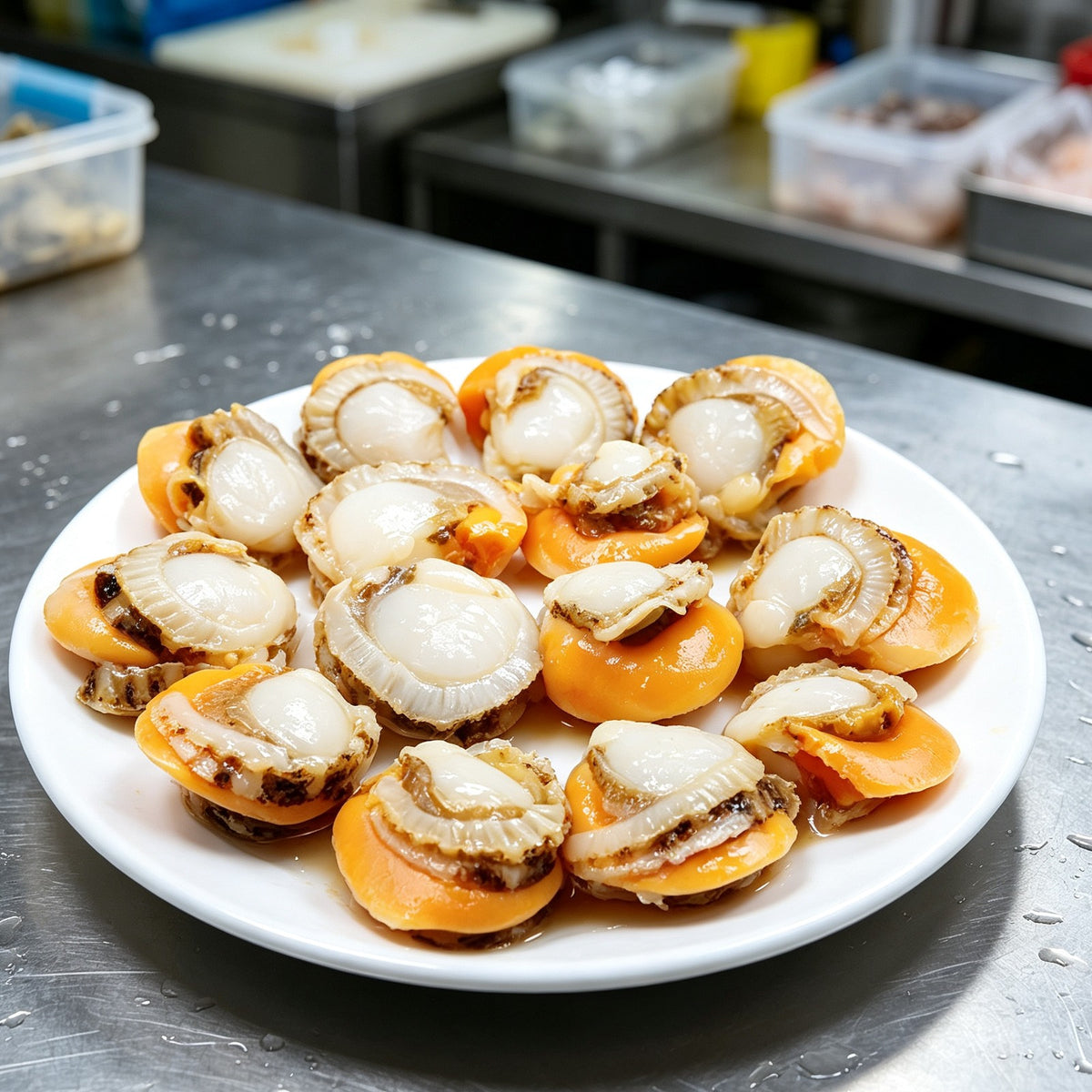 Half shell scallops with orange roe plated on a white dish